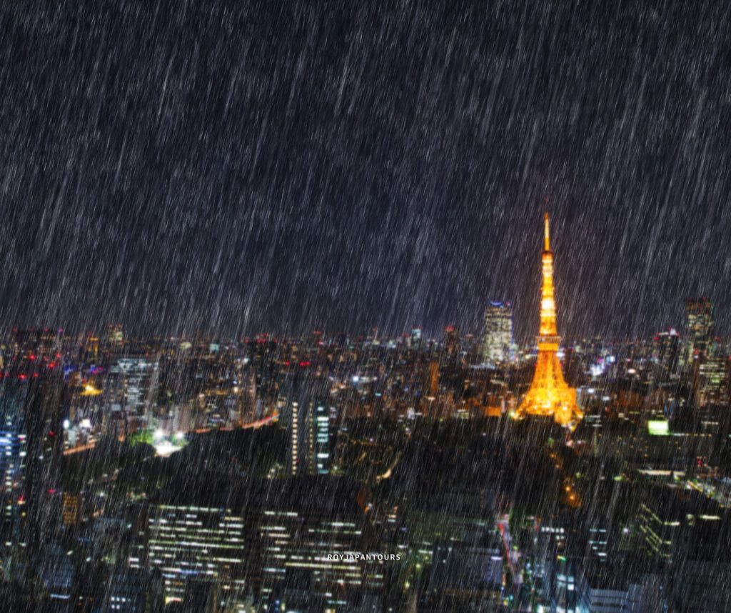 Rain-soaked Tokyo street illuminated by city lights on a rainy night